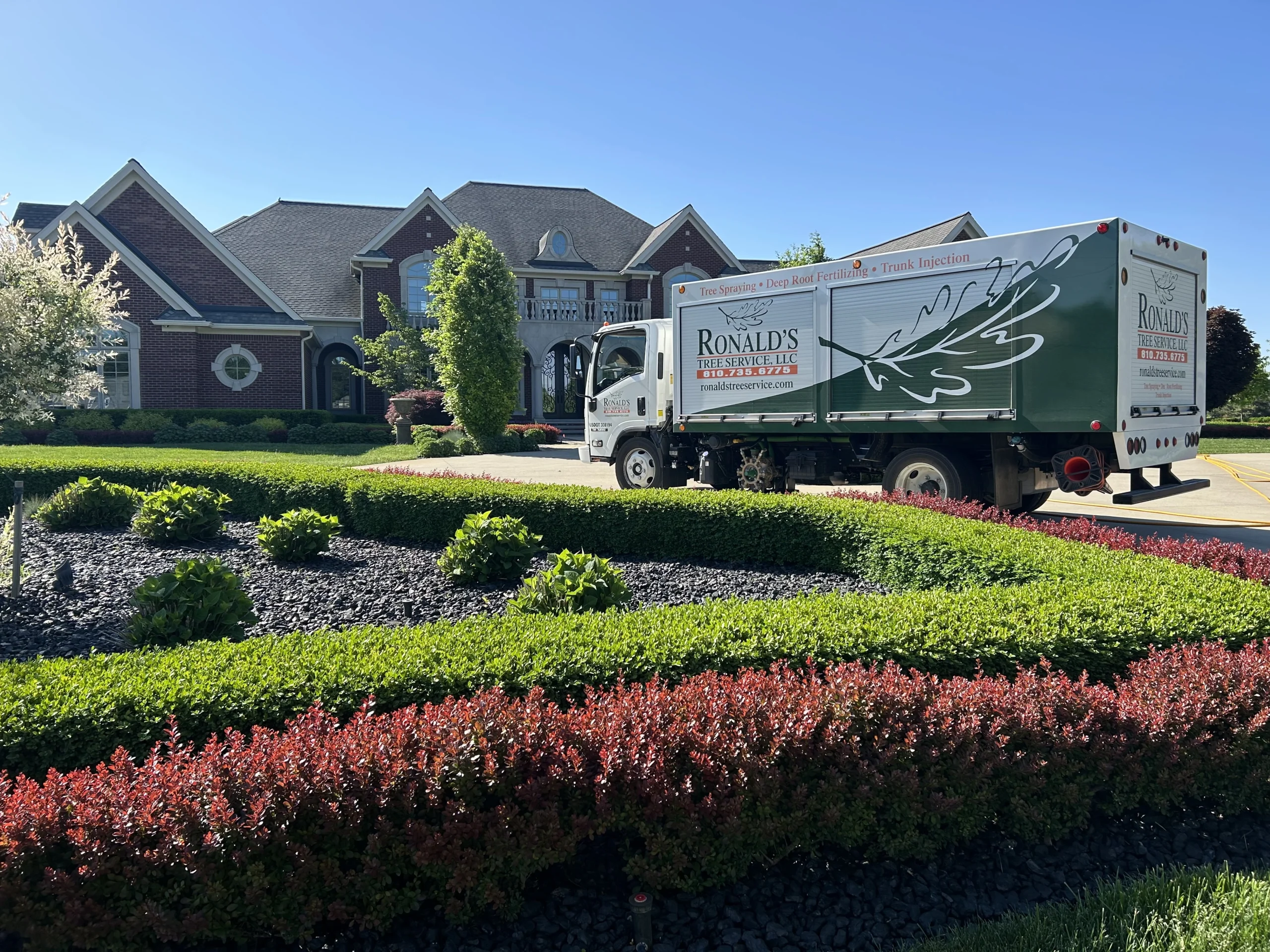 Ronald's Tree Service state-of-the-art work truck in front of a house in a residential neighborhood