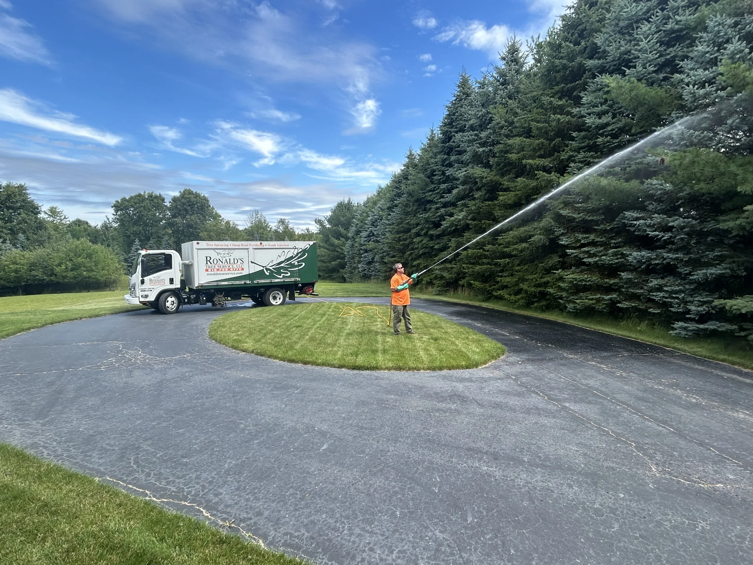 Ronald's Tree Service certified arborist conducting tree spraying for tree healthcare